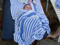Snuggled up in a towel after her swim