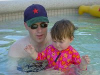 Swimming with Dad in the pool.