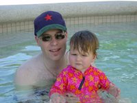 Swimming with Dad in the pool.
