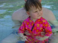 Swimming with Dad in the pool.
