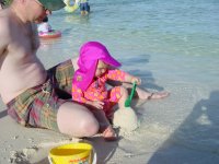Daddy introducing me to sea and sand .