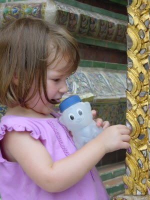 Lottie looking at her self in the mirrors set into the gold work.