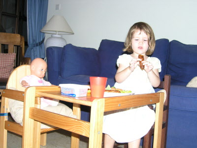 Hlyy and Lottie having sausages for supper.