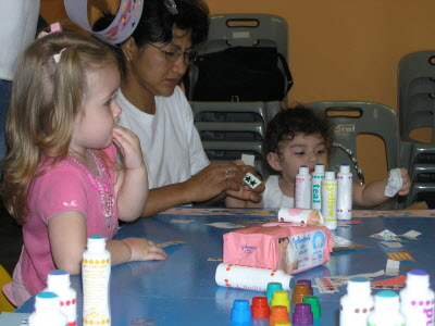 Isablelle and Josyln making party hats.