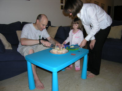 Cutting up birthday cake.
