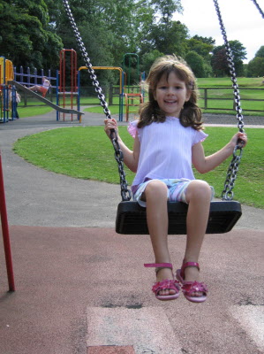 Lottie enjoying the swings