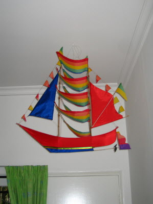 Daddy finally put a hook in the ceiling to hang the Bali boat kite.