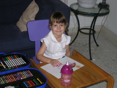 Lottie colouring pictures of her little brother.