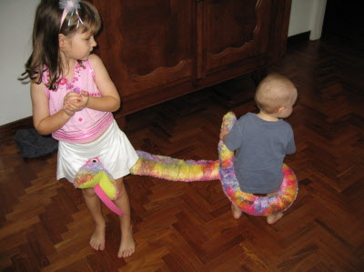 Lottie pretending to ride a snake and Conrad following at the tail...