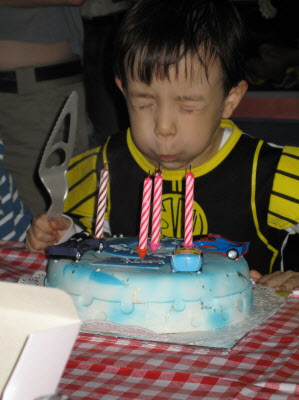 Sean blowing out his candles.