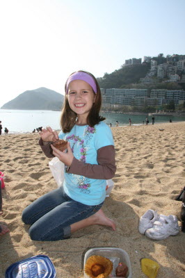 The birthday girl eating cake at Repulse Bay Beach