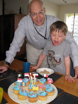 Peter and COnrad blowing out candles.