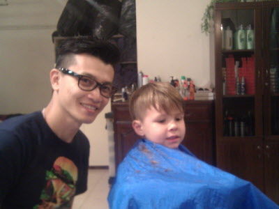 Raymond cutting Conrad's hair.